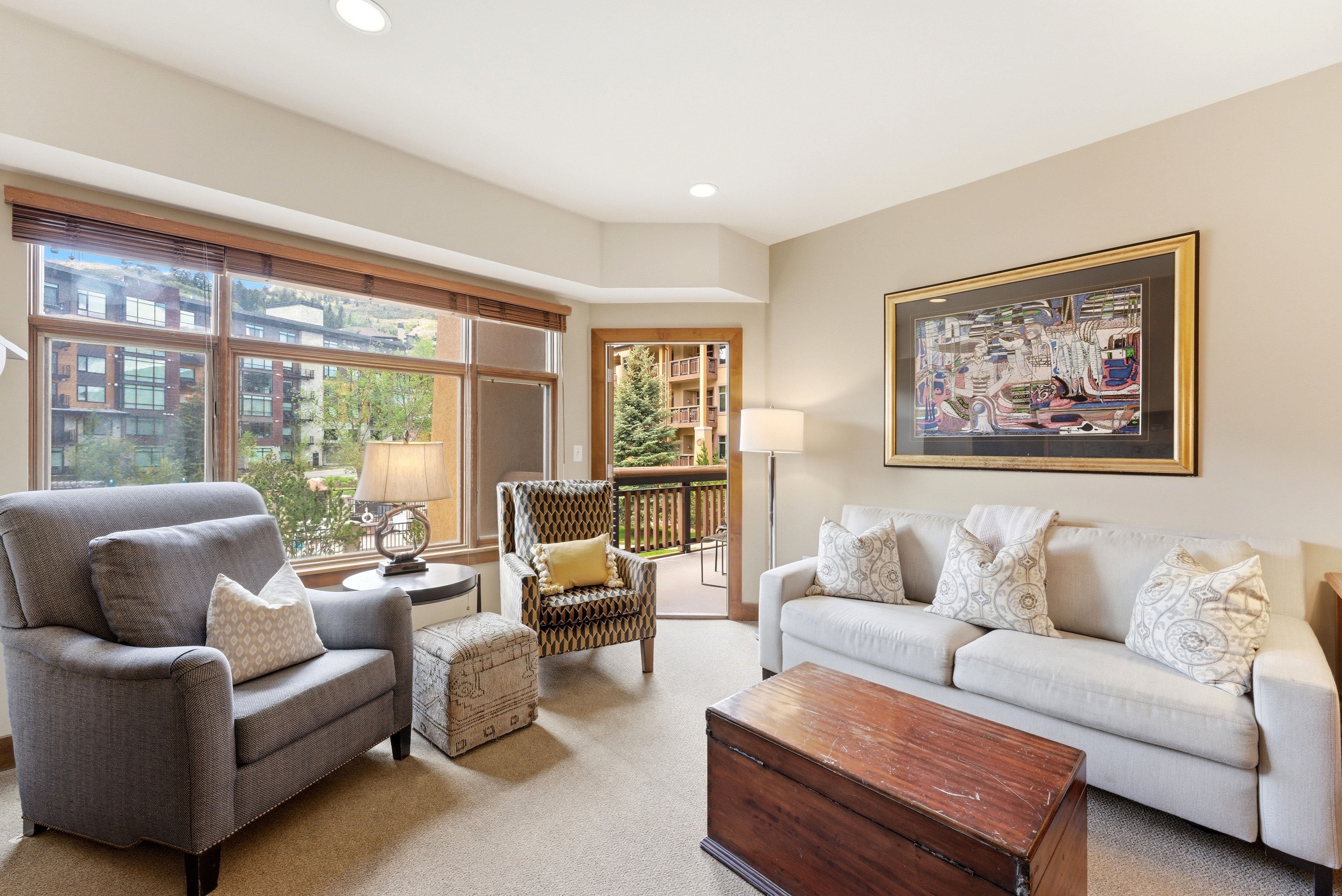 Living area featuring a wall of windows, recessed lighting, and access to an outdoor balcony