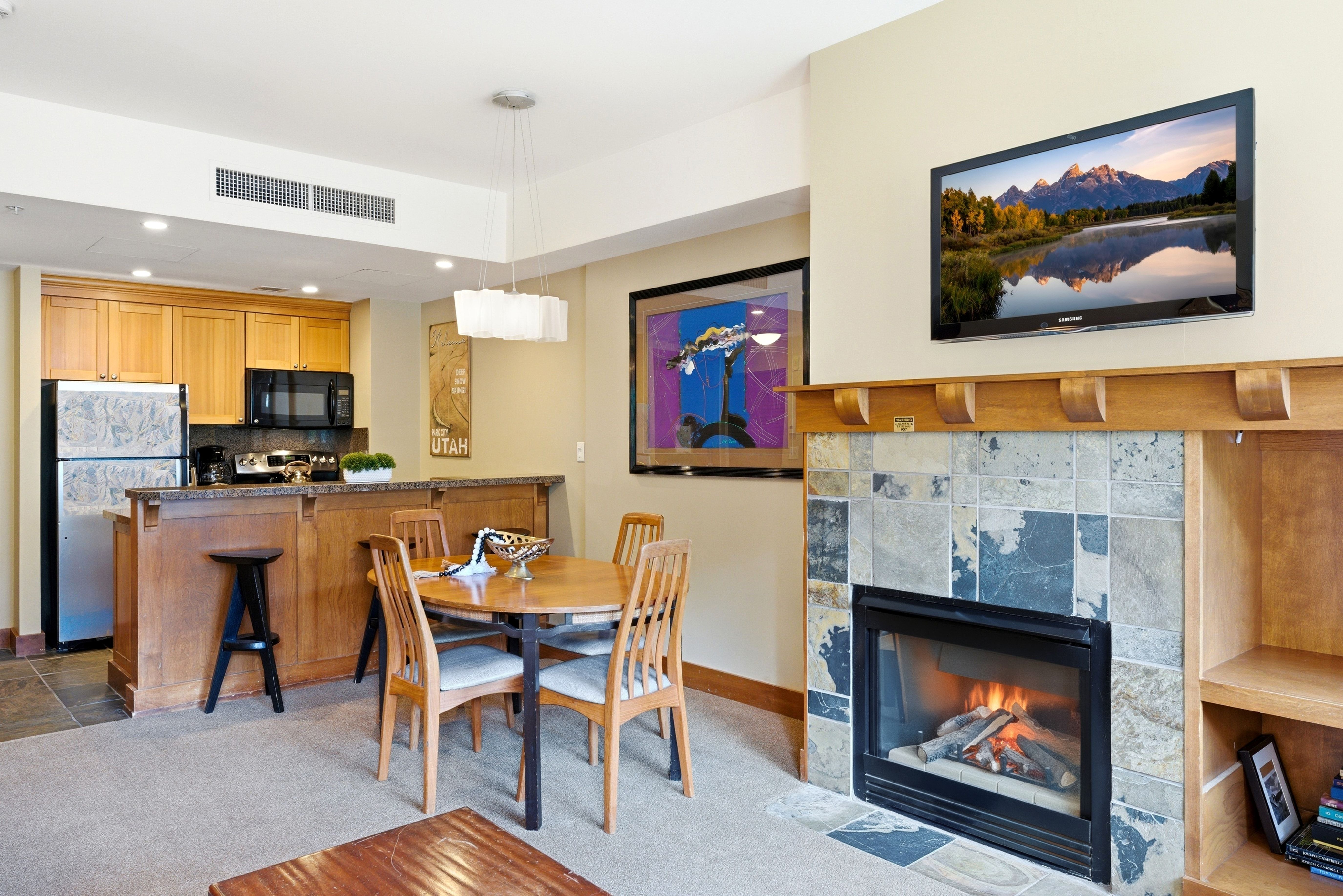 Living area featuring a fireplace with stone tile surround, an integrated media niche, and a natural wood mantel