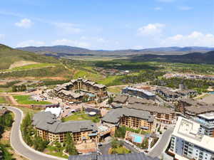 Expansive aerial perspective showcasing multiple residential buildings and surrounding green hillsides