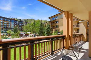Private balcony featuring a wood and metal railing system