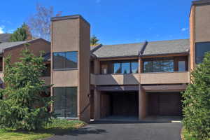 Multi-level facade featuring brick and stucco elements