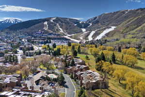 Expansive aerial perspective showcasing a mountainous landscape with ski slopes