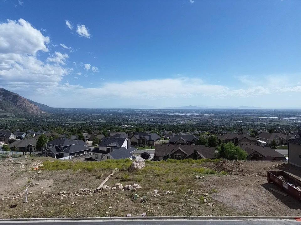 Expansive mountain and city vistas from a elevated lot