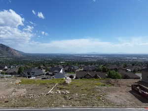 Expansive mountain and city vistas from a elevated lot