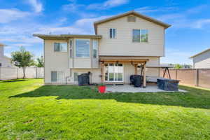 Expansive green lawn with a concrete patio, sliding glass door access, and an overhead wood pergola