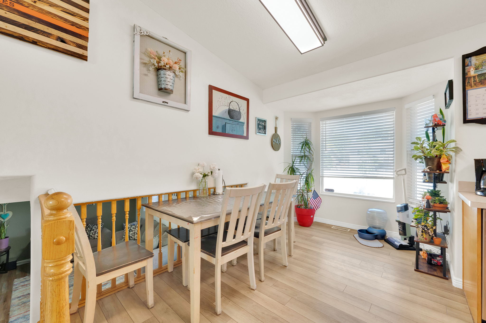 Light wood-finish flooring complements the white walls and trim