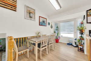 Light wood-finish flooring complements the white walls and trim