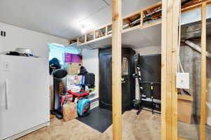 Unfinished basement area featuring exposed ceiling joists and wall framing