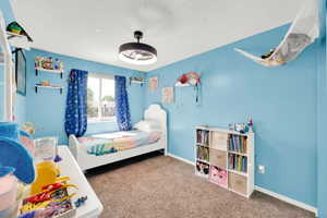 Recessed window with white trim, light blue walls, and textured carpet flooring