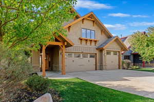 Craftsman-style facade featuring earth-toned siding and stone accents
