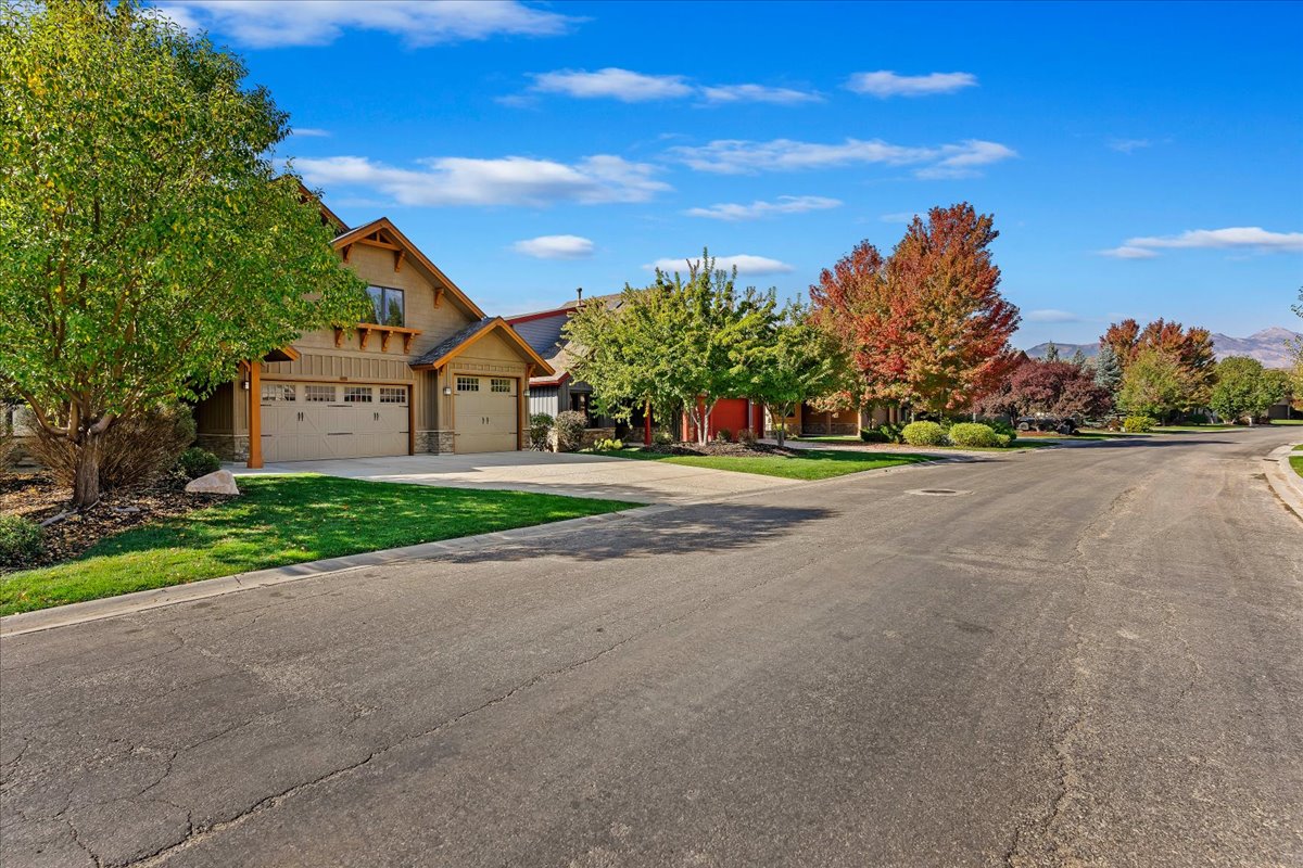 Craftsman-style exterior with a stucco and wood siding facade, a two-car garage, and an additional single-car garage