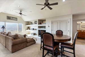 Open-concept living space with vaulted ceilings, recessed lighting, and dual ceiling fans