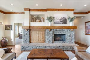 Stone-clad fireplace featuring a wood mantel and hearth