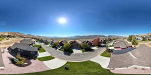 Residential street featuring a cul-de-sac, paved driveways, and landscaped front yards