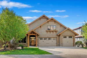 Craftsman-style exterior featuring a multi-gable roofline and warm-toned siding