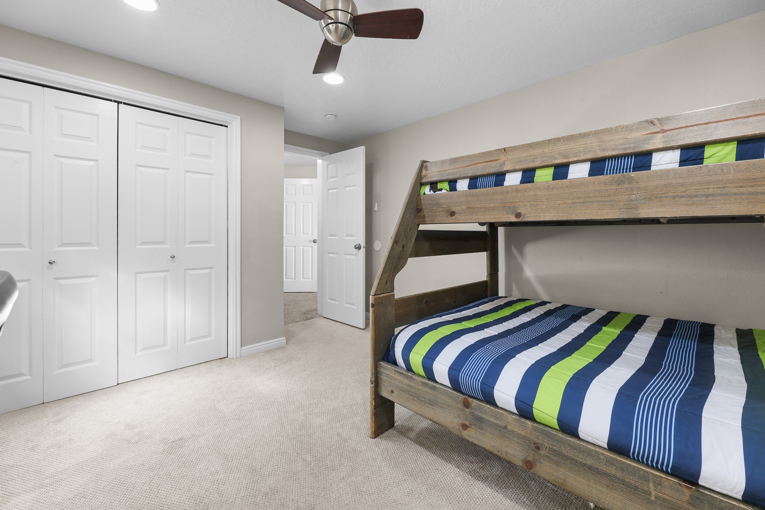 Bedroom featuring a flush-mount ceiling fan, recessed lighting, and soft carpet flooring