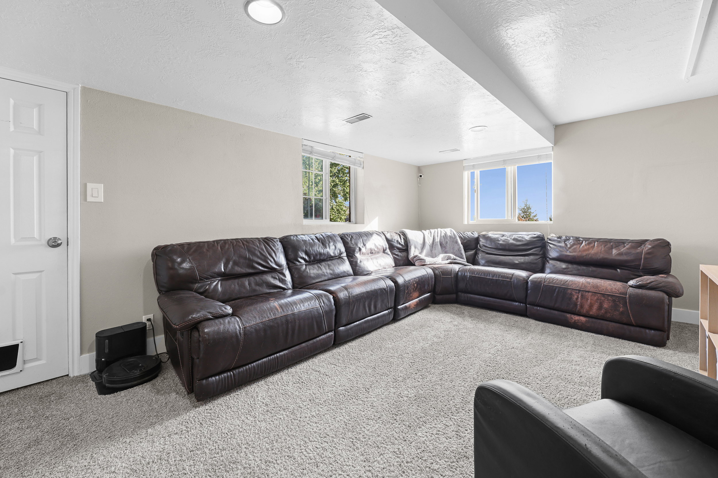 Carpeted room featuring recessed lighting and windows providing natural light