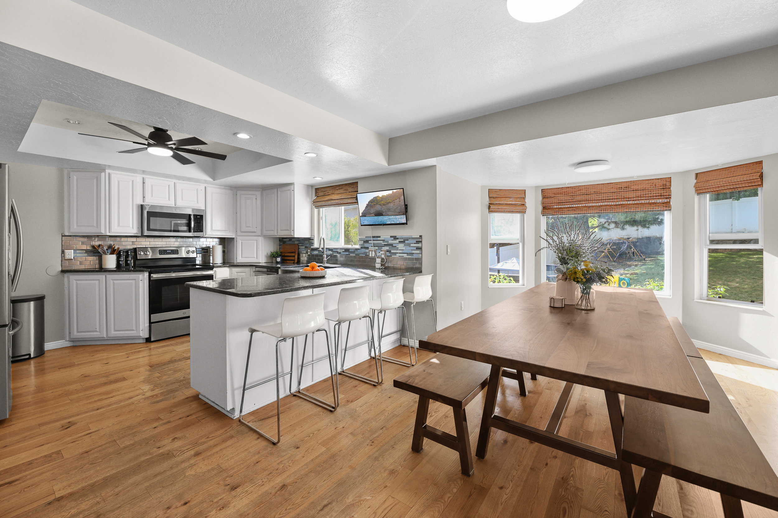 Open-concept kitchen and dining area featuring light wood-finish flooring