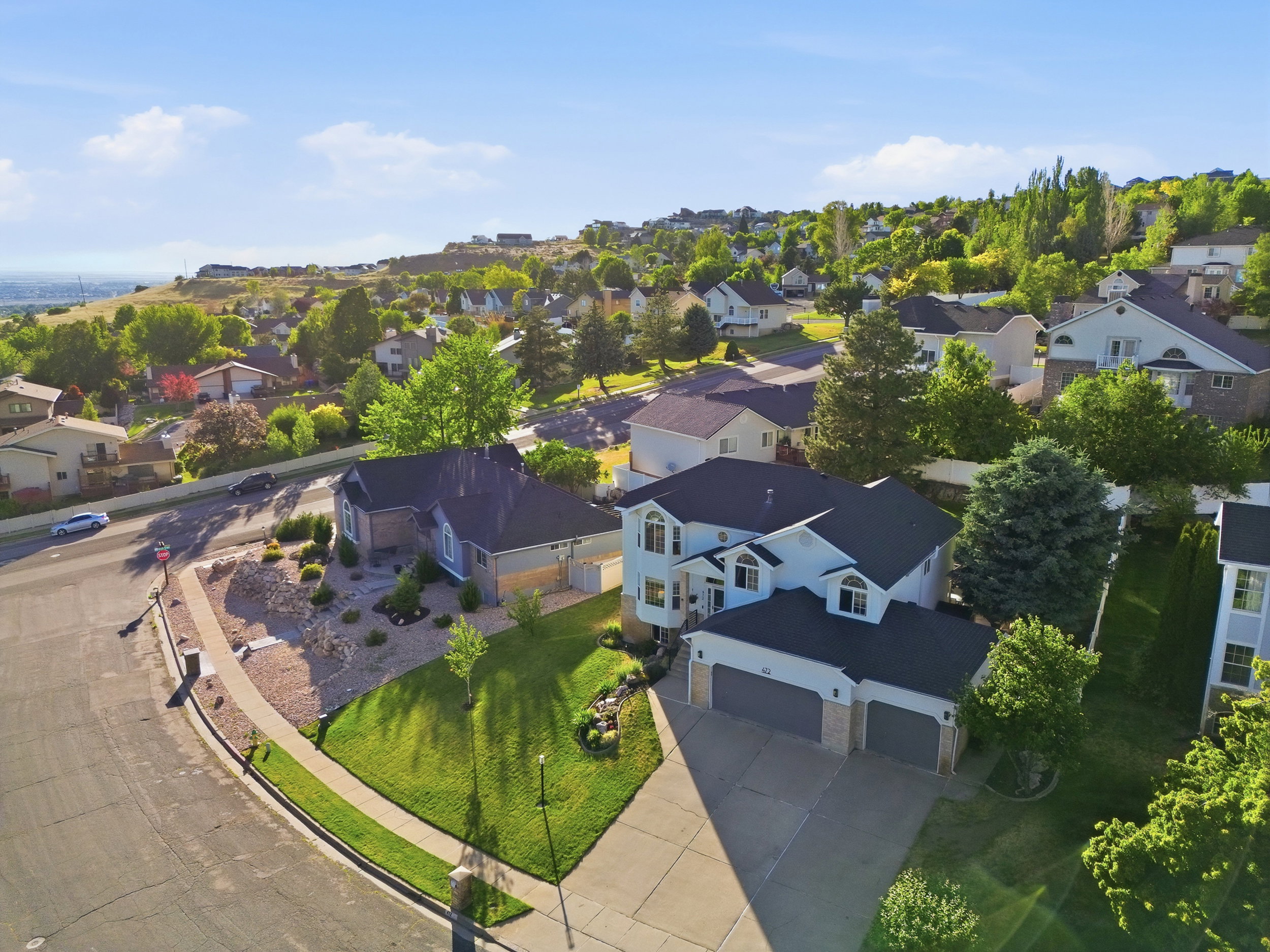 Two-story residence with a three-car garage and a paved driveway