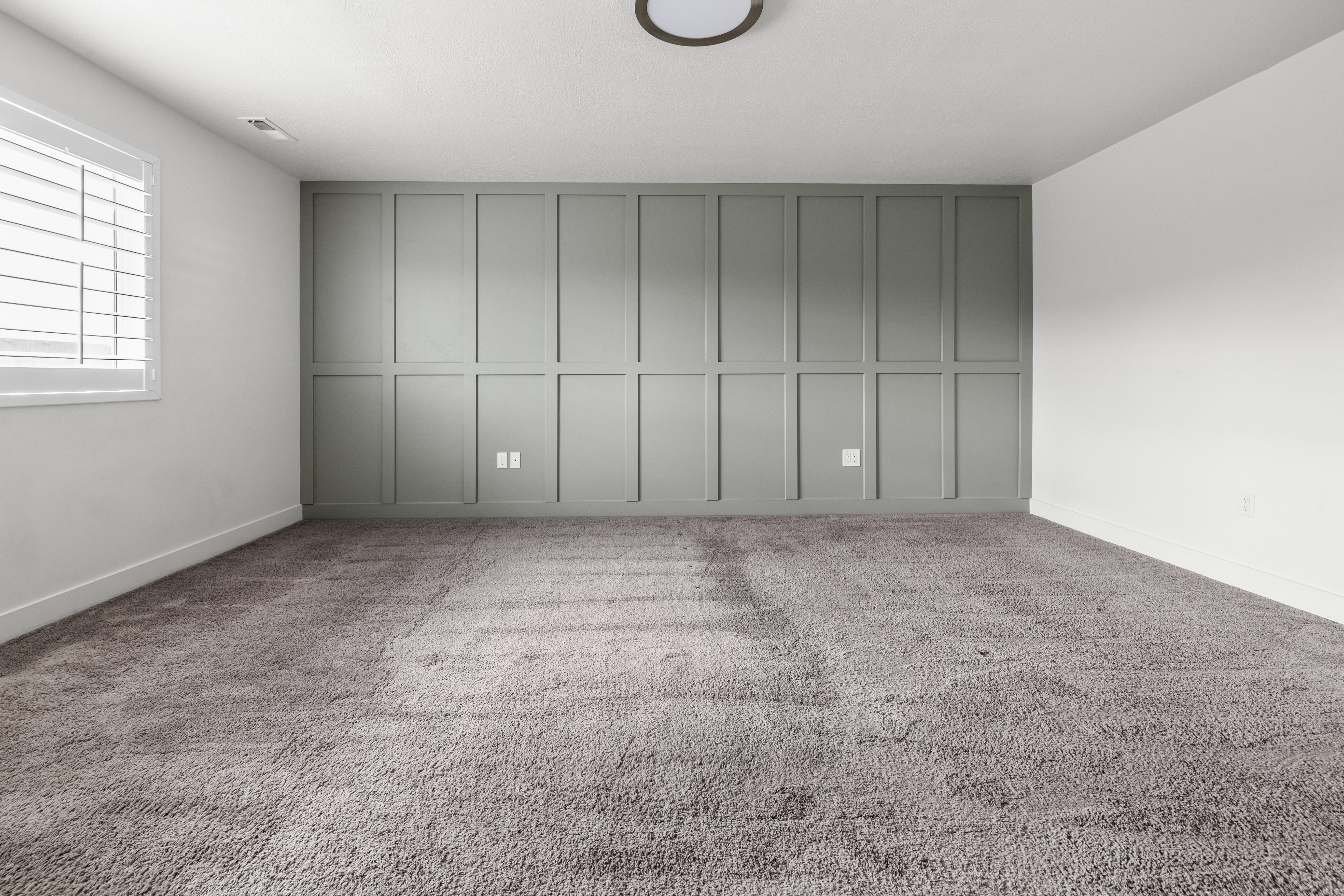 Primary Bedroom. Accent wall featuring board and batten paneling