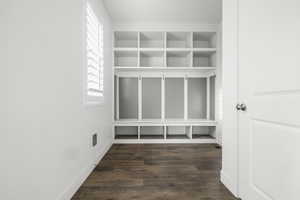 Built-in entryway storage system featuring cubbies, hooks, and bench seating