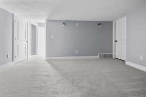 Carpeted room with light gray walls, white baseboards, and two paneled doors