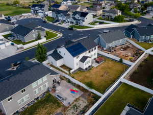 White two-story residence with a dark roof and installed solar panels