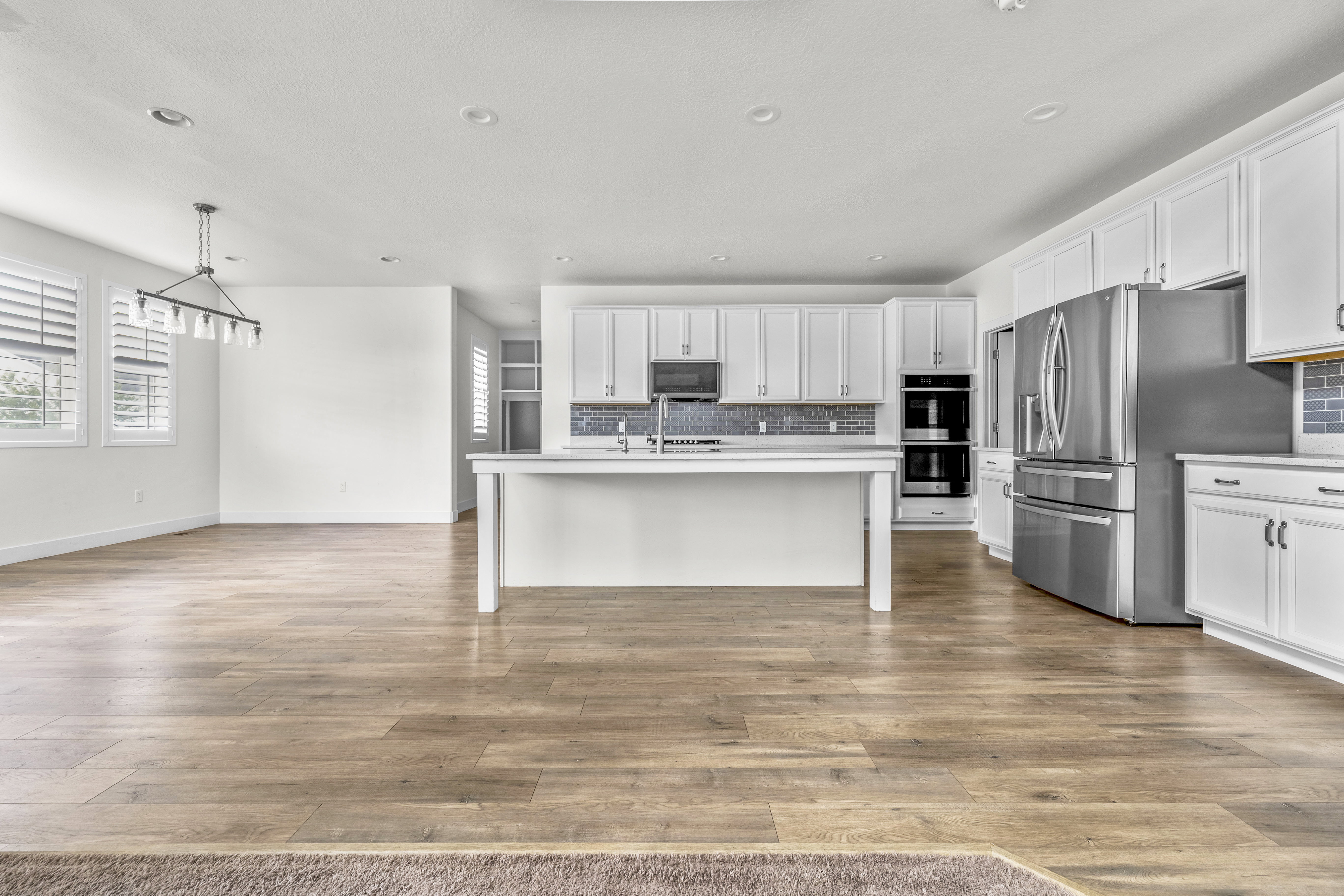 Open-concept living space featuring wood-finish flooring