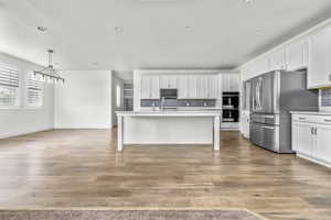 Open-concept living space featuring wood-finish flooring
