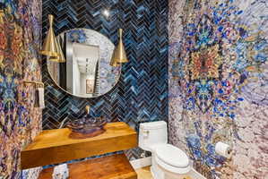 Half bath with tile walls and vanity