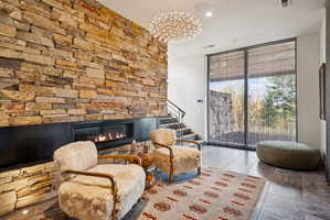 Sitting room with expansive windows, a fireplace, and recessed lighting