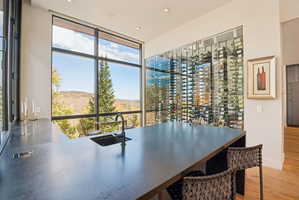 Wine room featuring recessed lighting, light wood-type flooring, and expansive windows