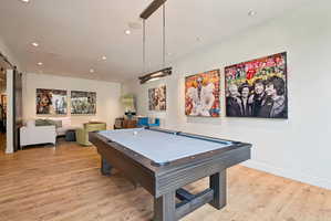 Rec room with recessed lighting, pool table, light wood finished floors, and a barn door
