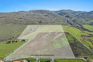 Expansive undeveloped parcel featuring varied terrain including open fields and a treed section