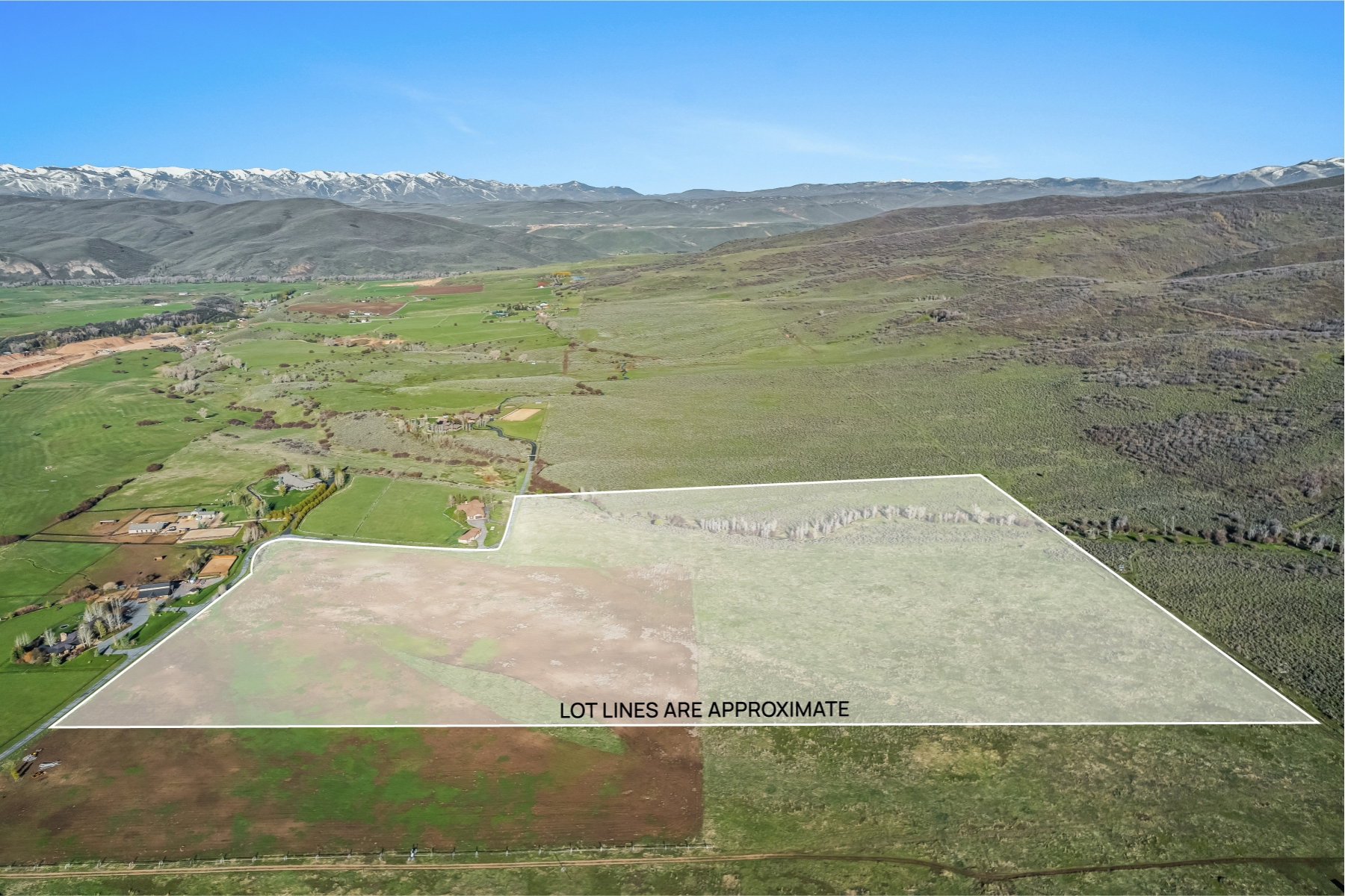 Expansive raw land parcel featuring varied terrain, including flat and sloped areas