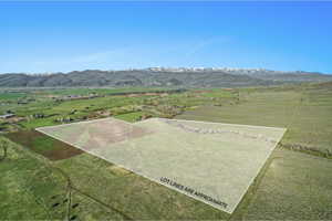 Expansive land parcel featuring open fields and distant mountain ranges