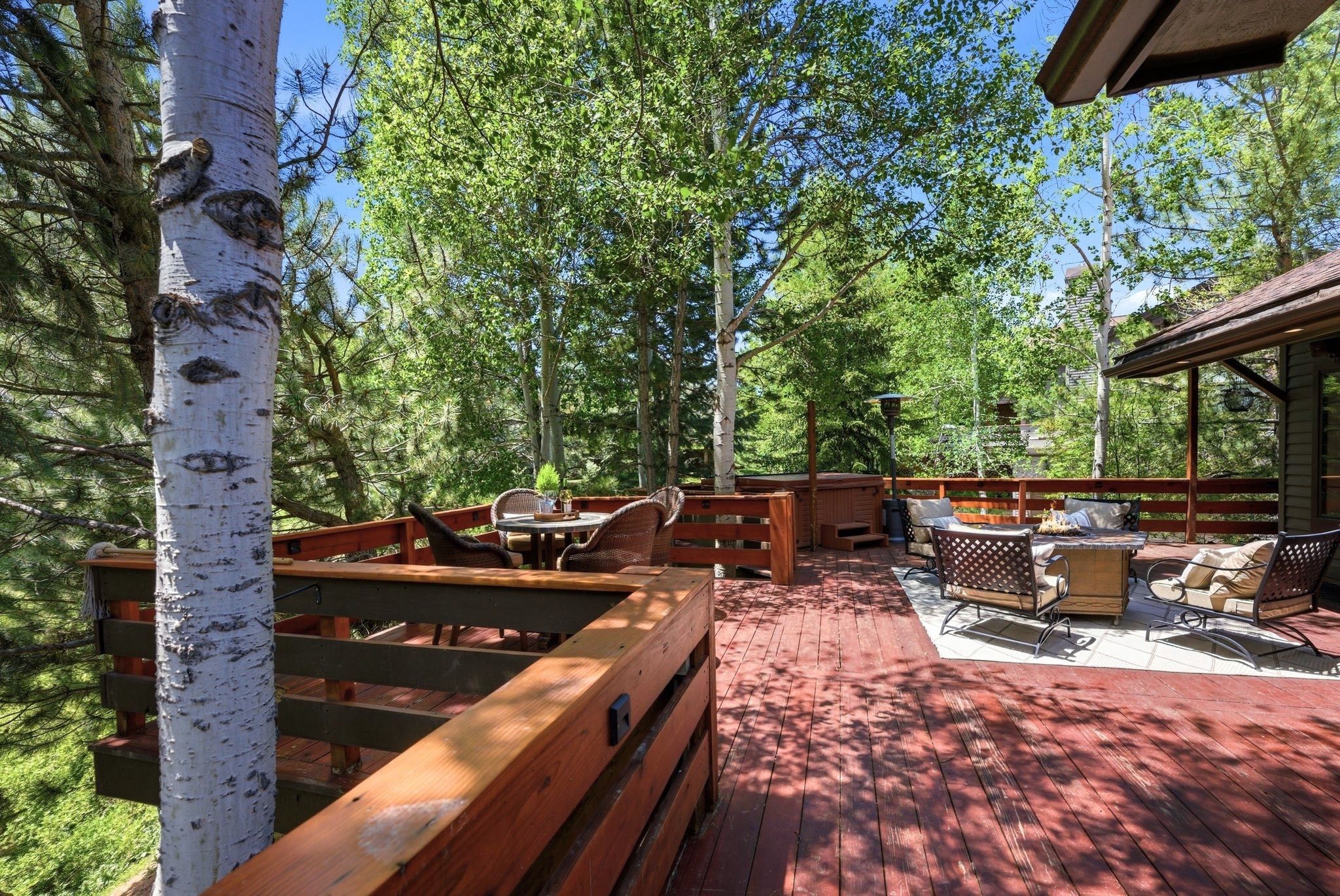 Multi-level wooden deck featuring a built-in railing system