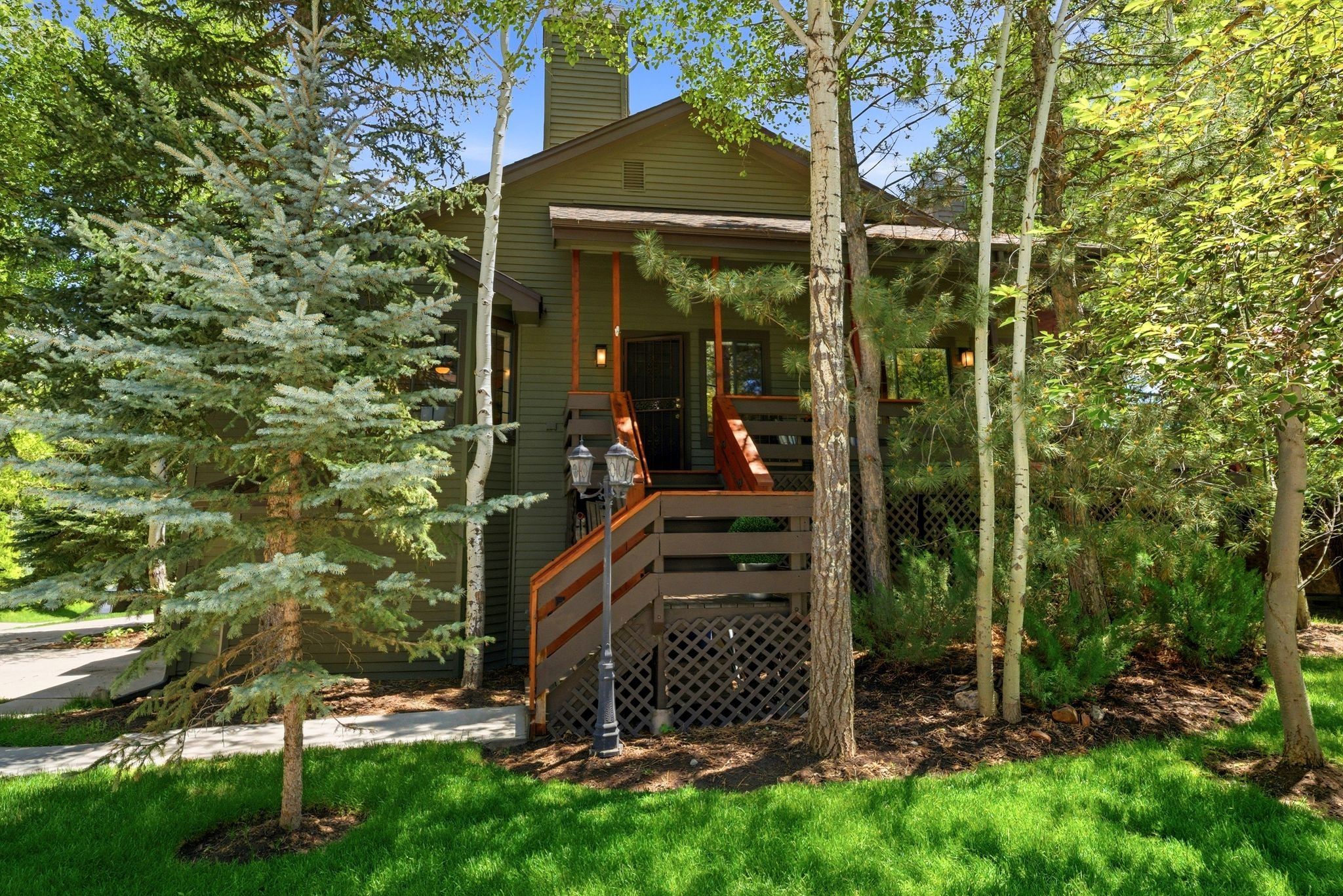 Exterior featuring a prominent wooden staircase, a covered porch, and horizontal siding
