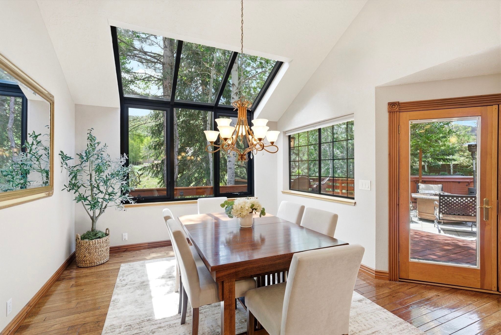 Dining area with a striking vaulted ceiling and extensive glass paneling