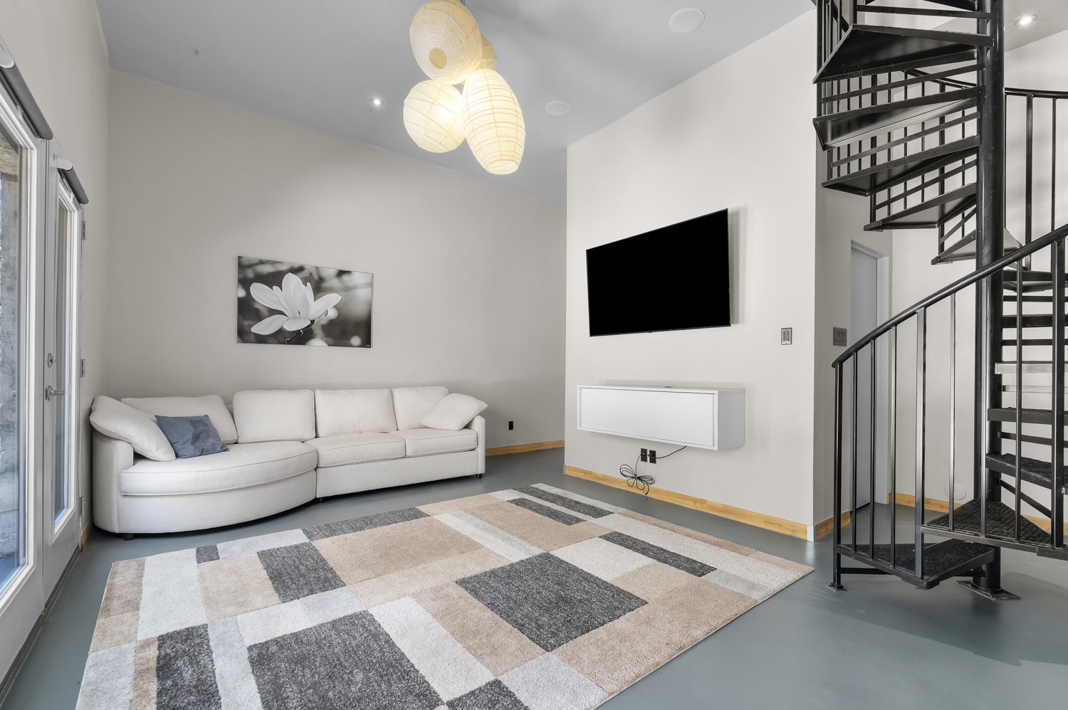 Vaulted ceiling with modern pendant lighting and recessed fixtures