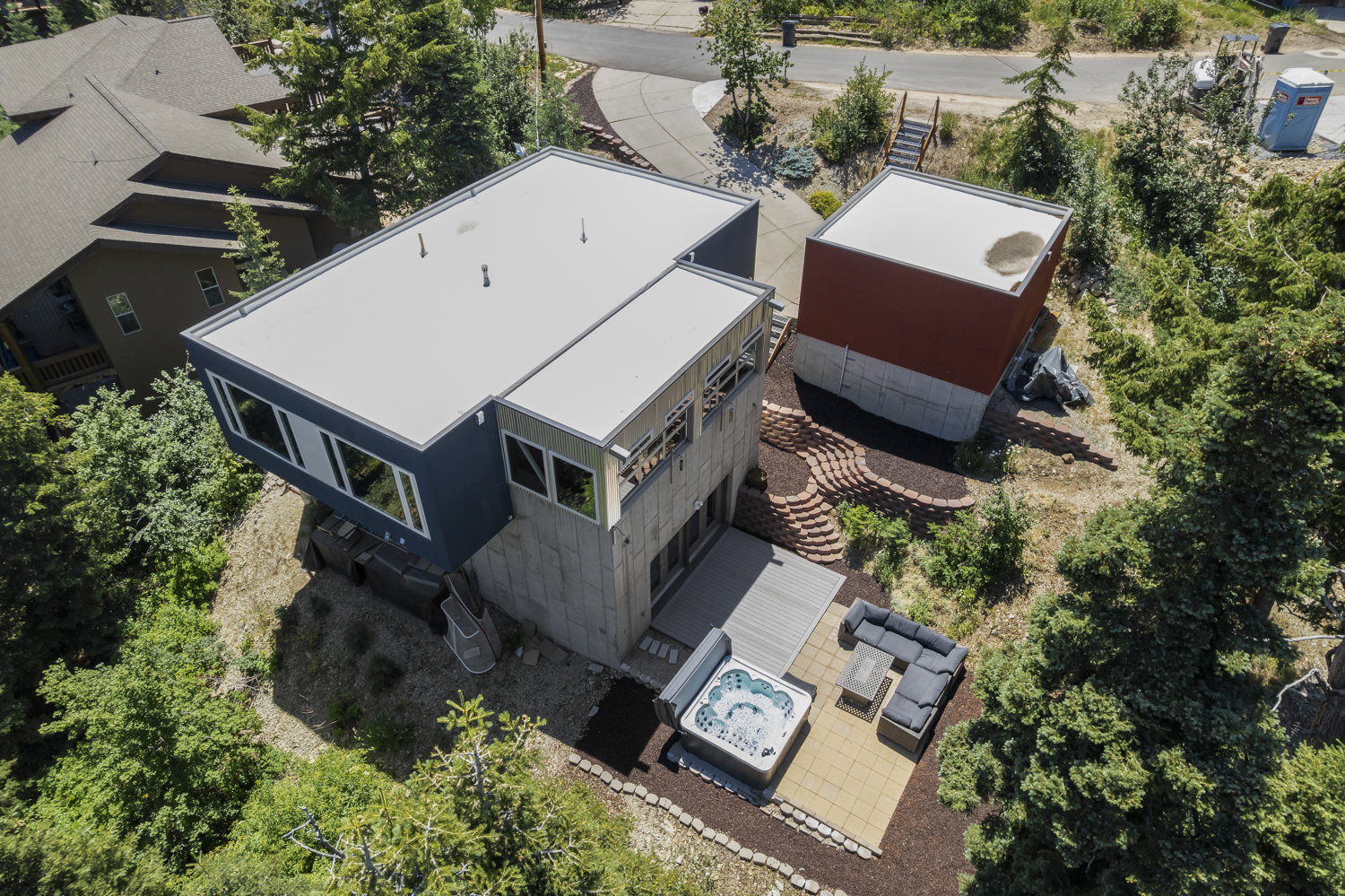 Contemporary multi-level exterior with flat rooflines, a private outdoor patio, and a separate detached structure