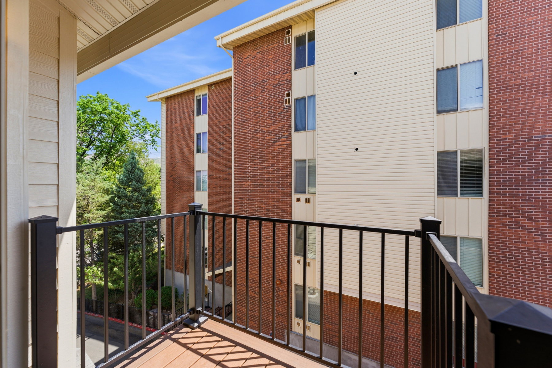 Private balcony with durable composite decking and black metal railings