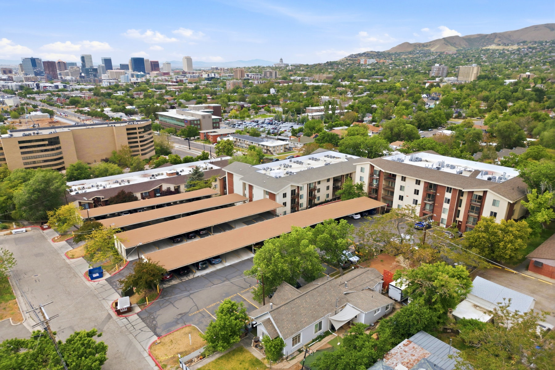 Aerial perspective showcasing a multi-story residential building with private balconies