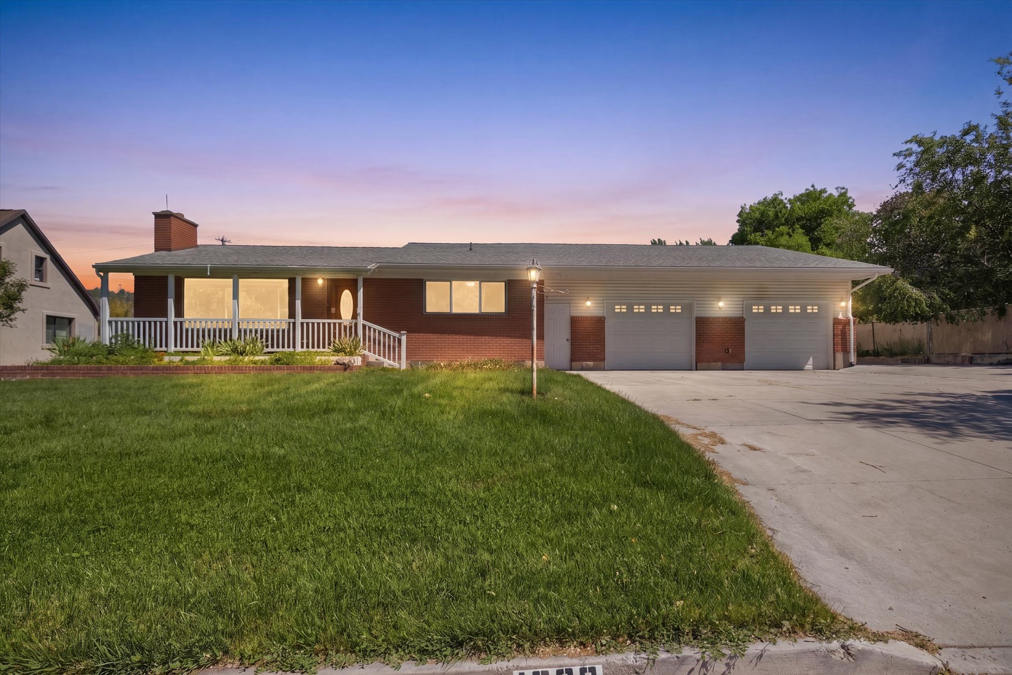 Ranch-style residence featuring a brick exterior and a covered front porch with white railings