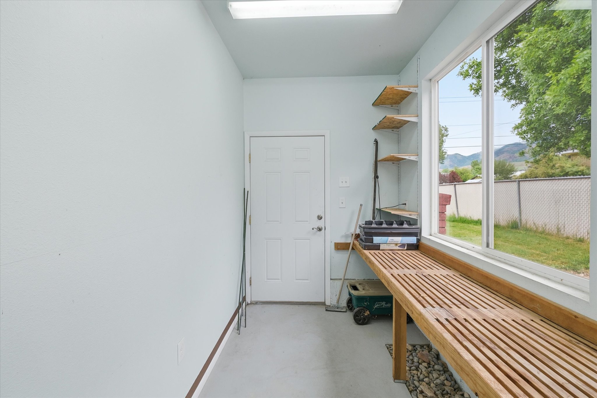 Dedicated utility room featuring light-toned walls and durable flooring