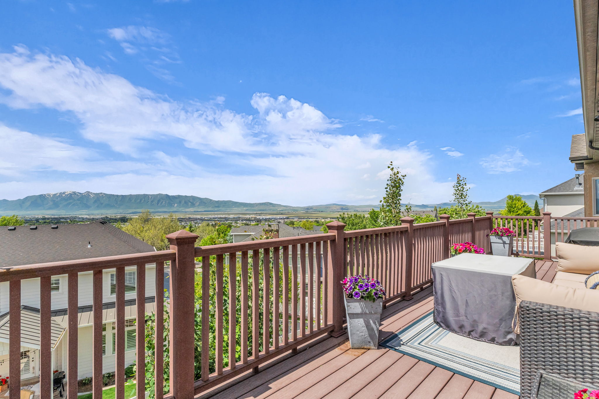 Expansive outdoor deck featuring composite wood-finish flooring and a sturdy wood-toned railing