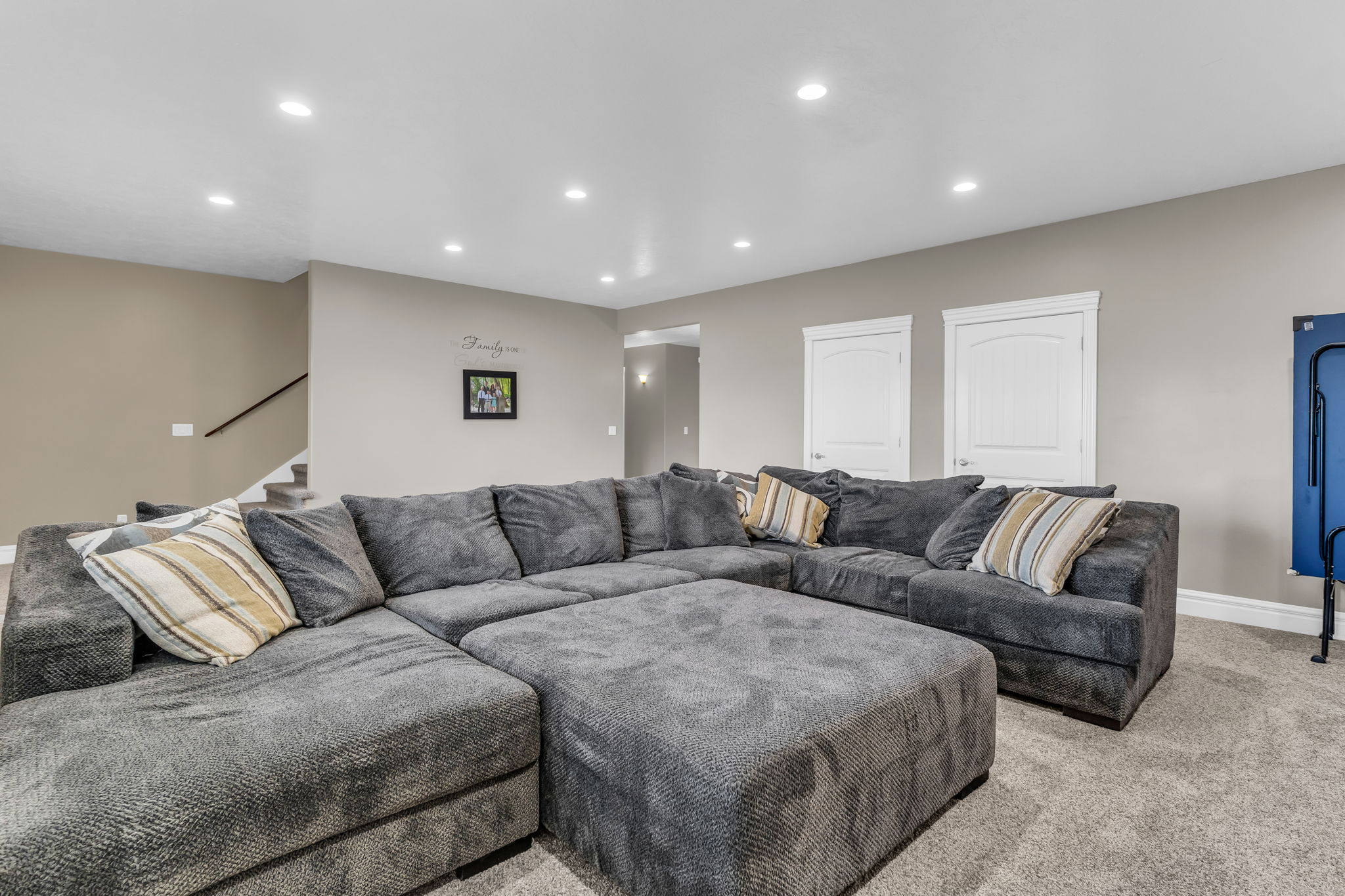 Spacious room featuring neutral-toned walls, recessed lighting, and carpet flooring