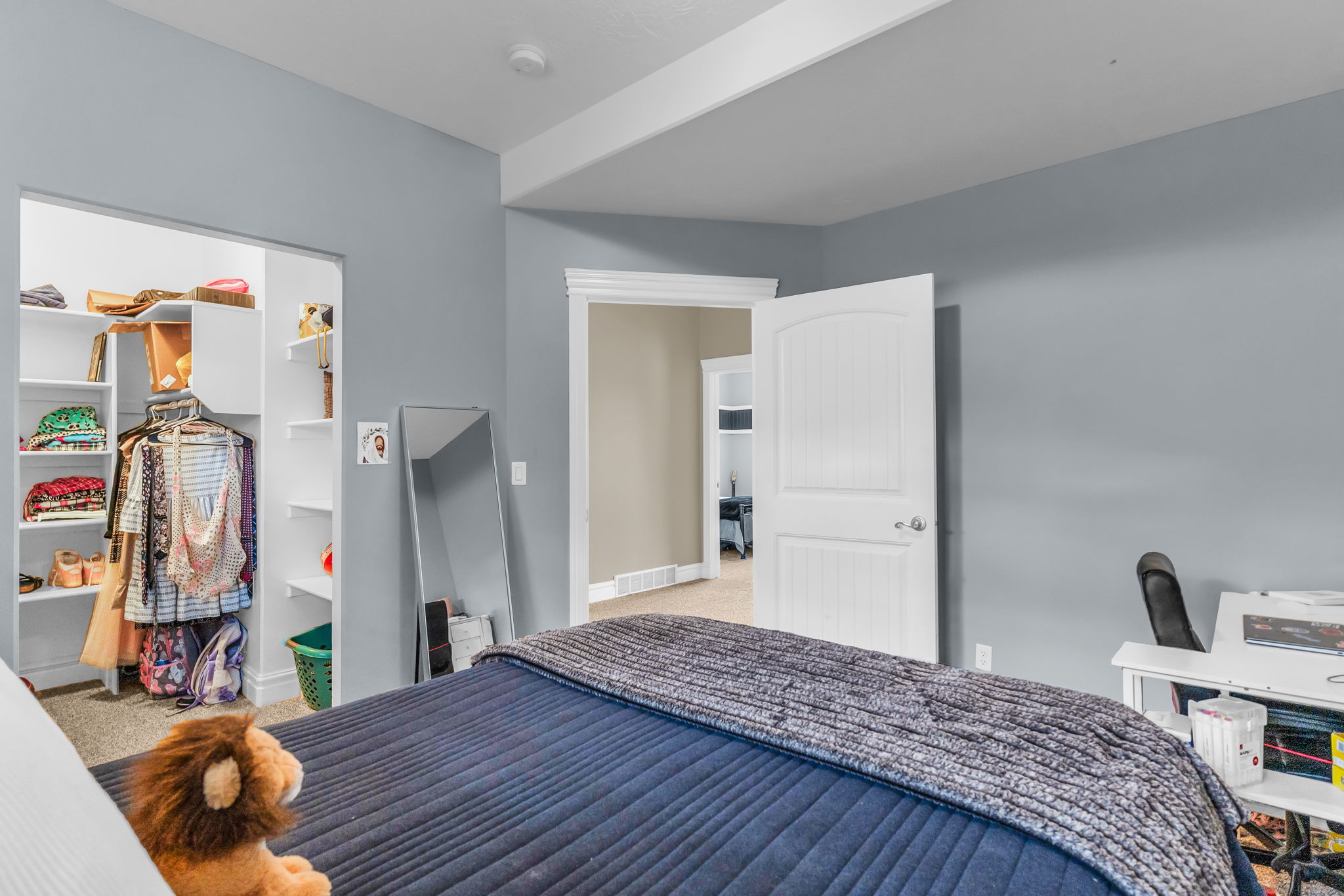 Built-in closet system featuring white shelving and hanging rods