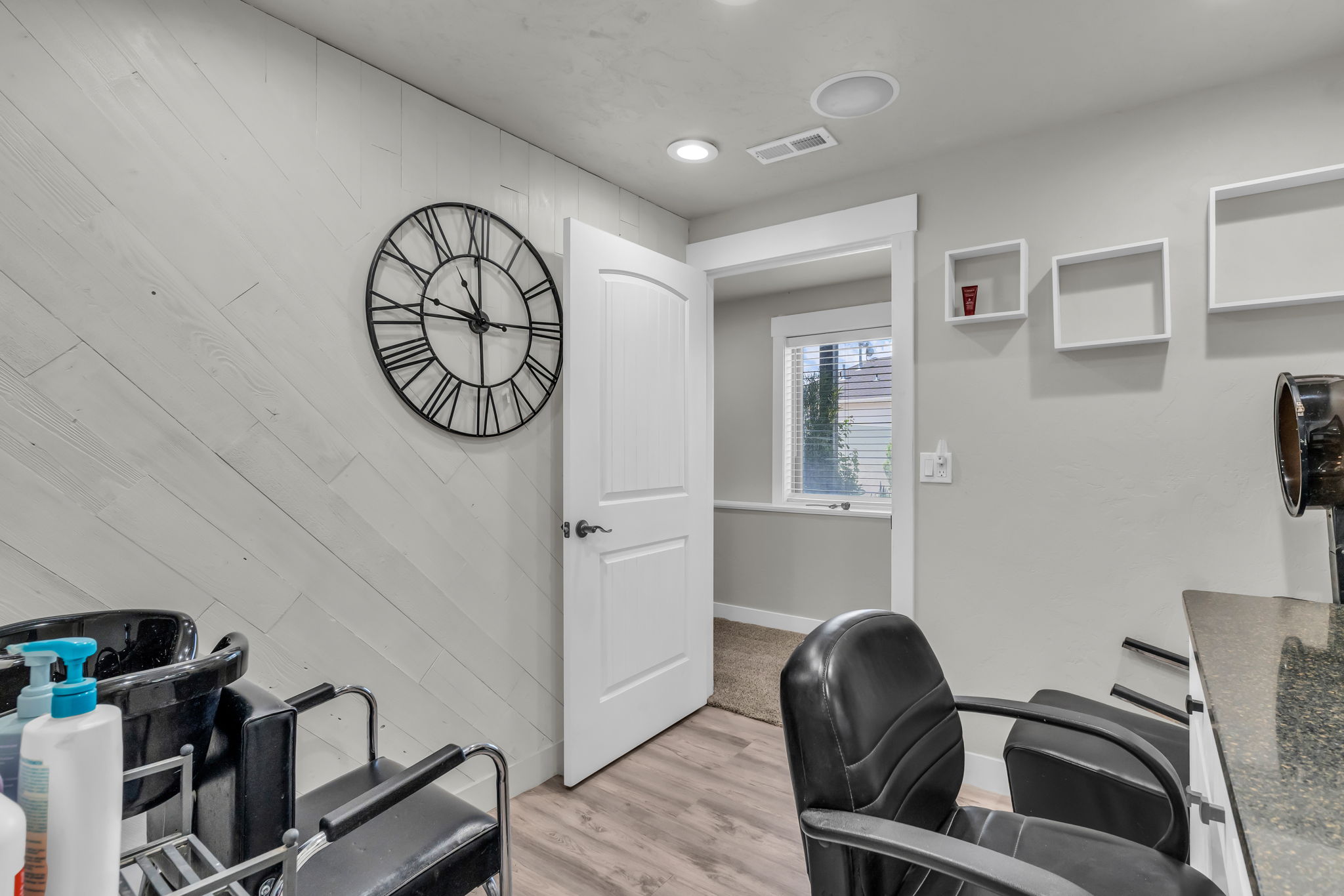 Light wood-finish flooring complements the horizontally paneled accent wall