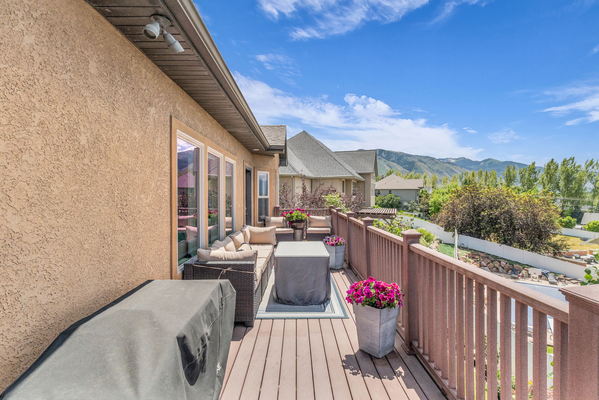 Expansive outdoor deck featuring wood-finish flooring and a durable railing system